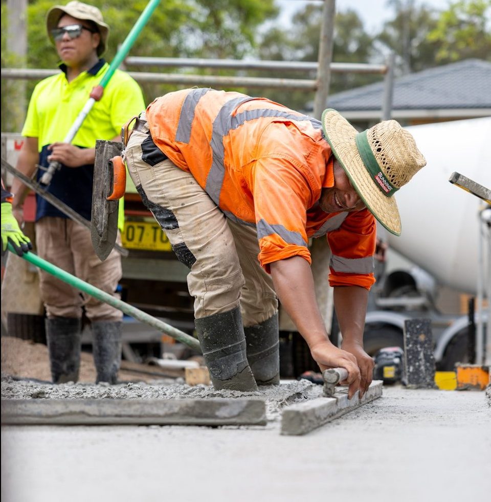 Construction workers are leveling concrete.
